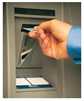 Man inserting debit card into ATM slot